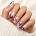 Love-inspired long-wear nail sticker manicure on a warm ivory background